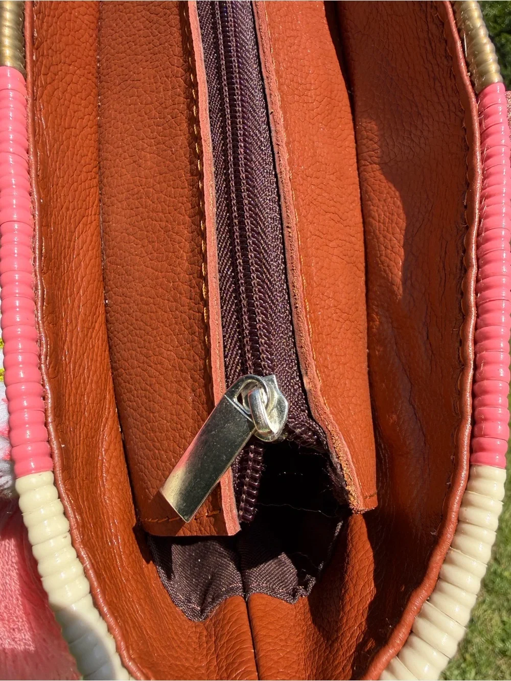 Woven Straw Tote Bag with Brown Leather Handles and Pink Tassel Accent